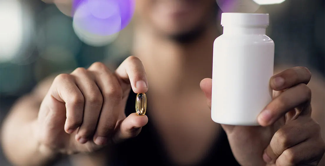 A boy holding best mens multivitamins for sports athletes.